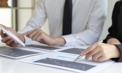 Accountants and financiers are brainstorming the analysis of revenue performance with stock graphs at meetings, Analysis of real estate investment and income tax data concept.