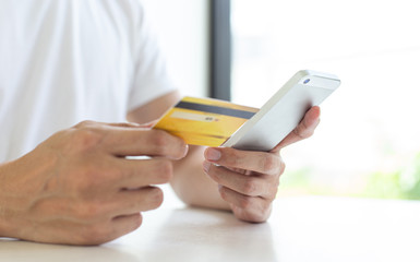 Men use smart phone to register online purchases using credit card payments, Convenience in the world of technology and the internet, Shopping online and banking online concept.