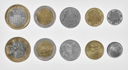 Close-up of the colombian coin family on both sides isolated on a white background