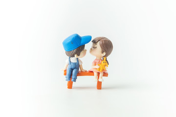 Mini cute doll of Couple little boy and little girl About to kiss isolate on White background