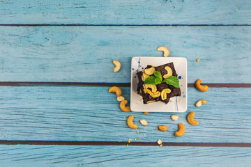 Topview Homemade chocolate brownie on a blue wood background , bakery and dessert