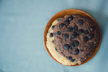 Top view of chocolate cookies on a bright blue background with copy space. Food photography style