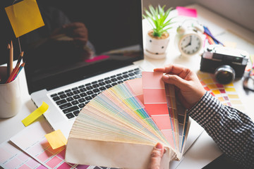 The graphic designer creative team is currently working on the design and color selection on the...