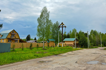 Old Russian village with a prayer cross.