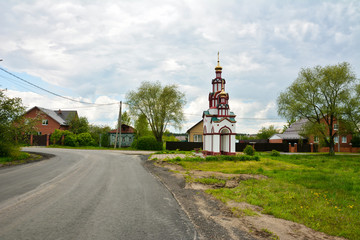 A small chapel on the street in the village. Spring.