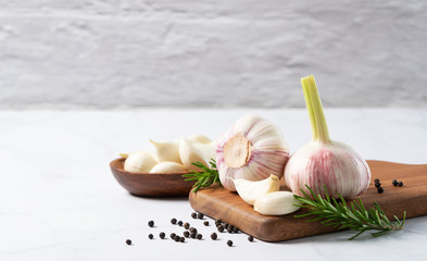 Marble table with garlic, herbs and spices