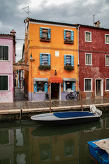 Fototapeta na wymiar colorful houses in Burano island near Venice in a cloudy day, Italy
