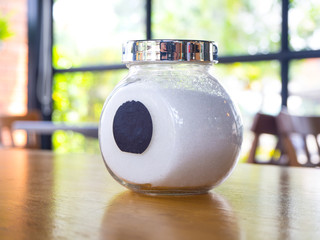Naklejka na ściany i meble sugar in A glass jar on wood table for coffee.