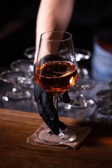 restaurant worker with gloves serving alcoholic drink
