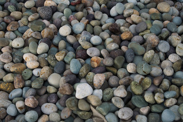 Colourful smooth beach rocks or pebbles. round pebbles piled together