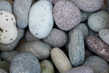Fototapeta na wymiar Abstract of smooth round pebbles. Beach rocks or pebbles. Purple and white pebbles
