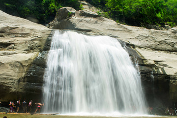 Tourist flock at the Tangadan falls in La Union Pangasinan Philippines. Big rock formations