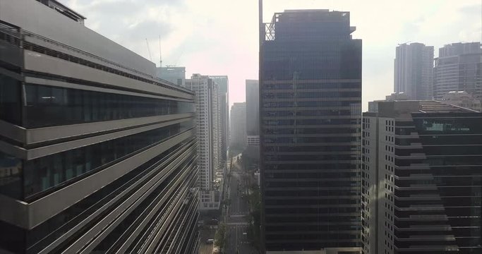 Straight aerial flight between skyscrapers in business district. Urban view. Drone, 4K. 

Frame rate: 23.98
Video Codec: ProRes 422HQ
Bonifacio Global City, BGC
Manila, Philippines