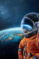 Spaceman and Earth planet behind. Astronaut on orbit. View from ISS. Elements of this image...