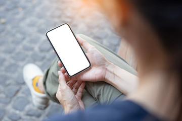 cell phone Mockup image blank white screen.woman hand holding texting using mobile on desk at coffee shop.background empty space for advertise.work people contact marketing business,technology