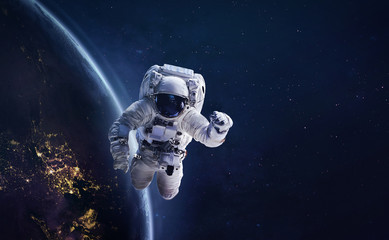 Fototapeta na wymiar Astronaut in outer space on orbit of the planet Earth. Abstract wallpaper with spaceman. View from ISS station. Elements of this image furnished by NASA 