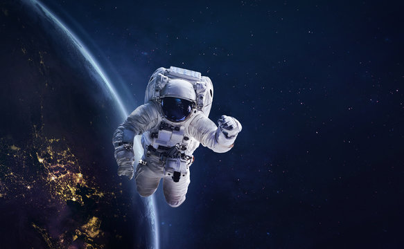Astronaut in outer space on orbit of the planet Earth. Abstract wallpaper with spaceman. View from ISS station. Elements of this image furnished by NASA	
