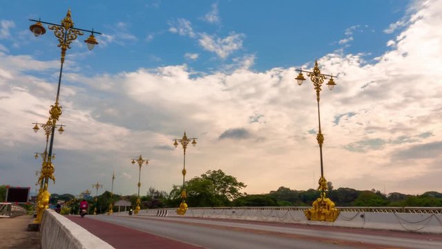RL Pan time lapse of traffic on road in northern Thailand with beautiful clouds moving in blue sky. Landscape, traffic, transport and environment concept.
