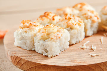 Baked shrimp rolls on wooden board top view