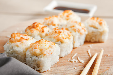 Baked shrimp rolls on wooden board top view