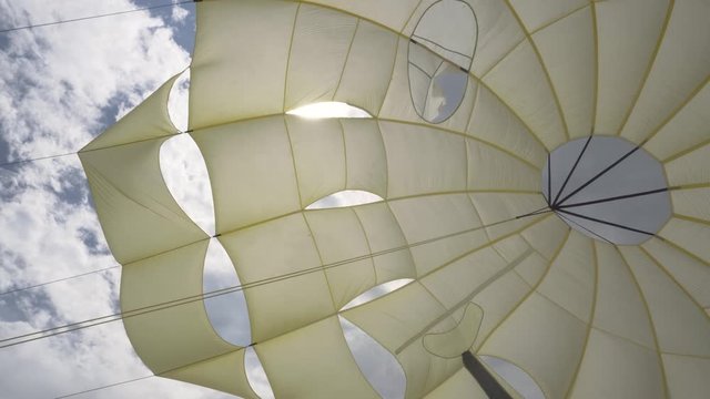 View of the Inside of a Parachute flying with a strong wind and sunlight.