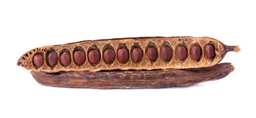 Ripe carob pods and bean isolated on white background.