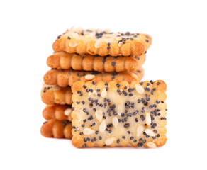 Square poppy seeds and sesame crackers isolated on white background. Dry cracker cookies isolated. Salty snacks isolated.