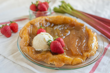 Rhubarb upside down cake with strawberries and ice cream