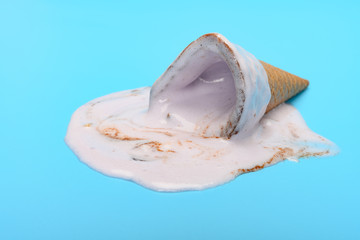 Obraz na płótnie Canvas sweet potato flavor ice cream cone melted on blue background