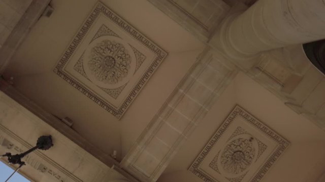 Vertigo spinning shot of ceiling architectural detail of portico in Paris