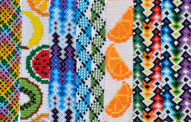 Selective focus of colorful friendship bracelets handmade of knots