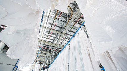 Washed towels are being conveyed to ironing and folding machine