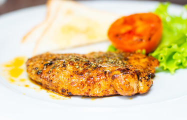 Grilled pork steak and tometo vegetables on dish