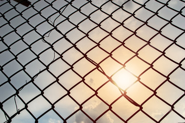 Fototapeta premium wire fence , lighting sun background