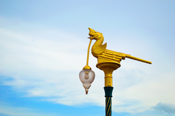 gold naga thai animal in tales street lamp  with blue sky
