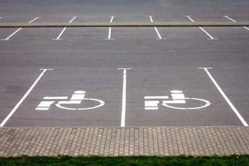 Handicap parking spot, white sign on black asphalt