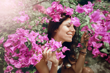 Close up portrait   girl in the park on a background of pink flowers       