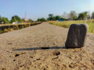 selective focus on stone and long shadow