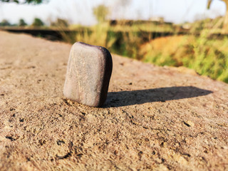 selective focus on stone and long shadow
