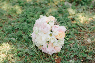 Obraz na płótnie Canvas Beautiful wedding bouquet for the bride with pink peonies and white peony roses