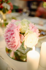 Pink peonies and roses in a wedding decor.