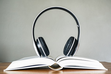 Hardcover book with headphone. Audio book concept.