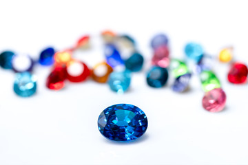 Blue sapphire  with group of gems on background