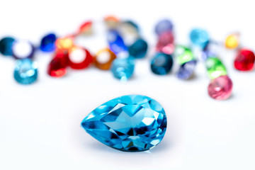 Blue sapphire  with group of gems on background