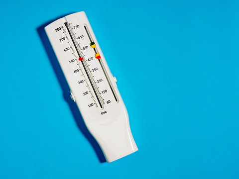 Medical Device Peak Flow Meter On A Blue Background