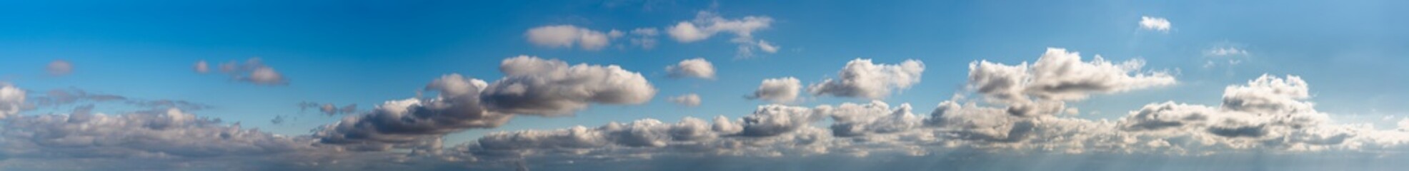 Fantastic clouds against blue sky, panorama