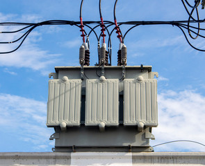 transformer on concrete pole with blue sky background