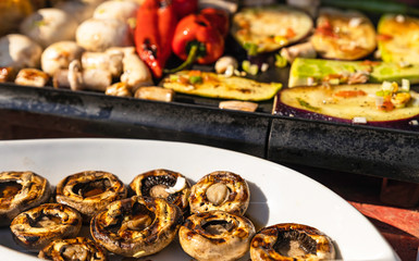 grilled mushrooms and vegetables on a grill, healthy food for dinner.