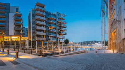 Oslo, Norway. Night View Of Residential Multi-storey Houses In Aker Brygge District. Summer Evening. Residential Area. Famous And Popular Place - obrazy, fototapety, plakaty