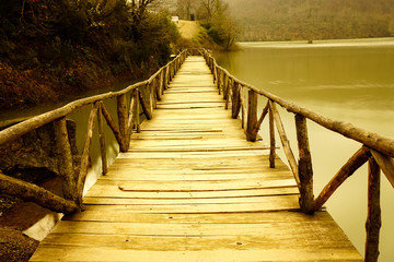 old wooden bridge on lake.
